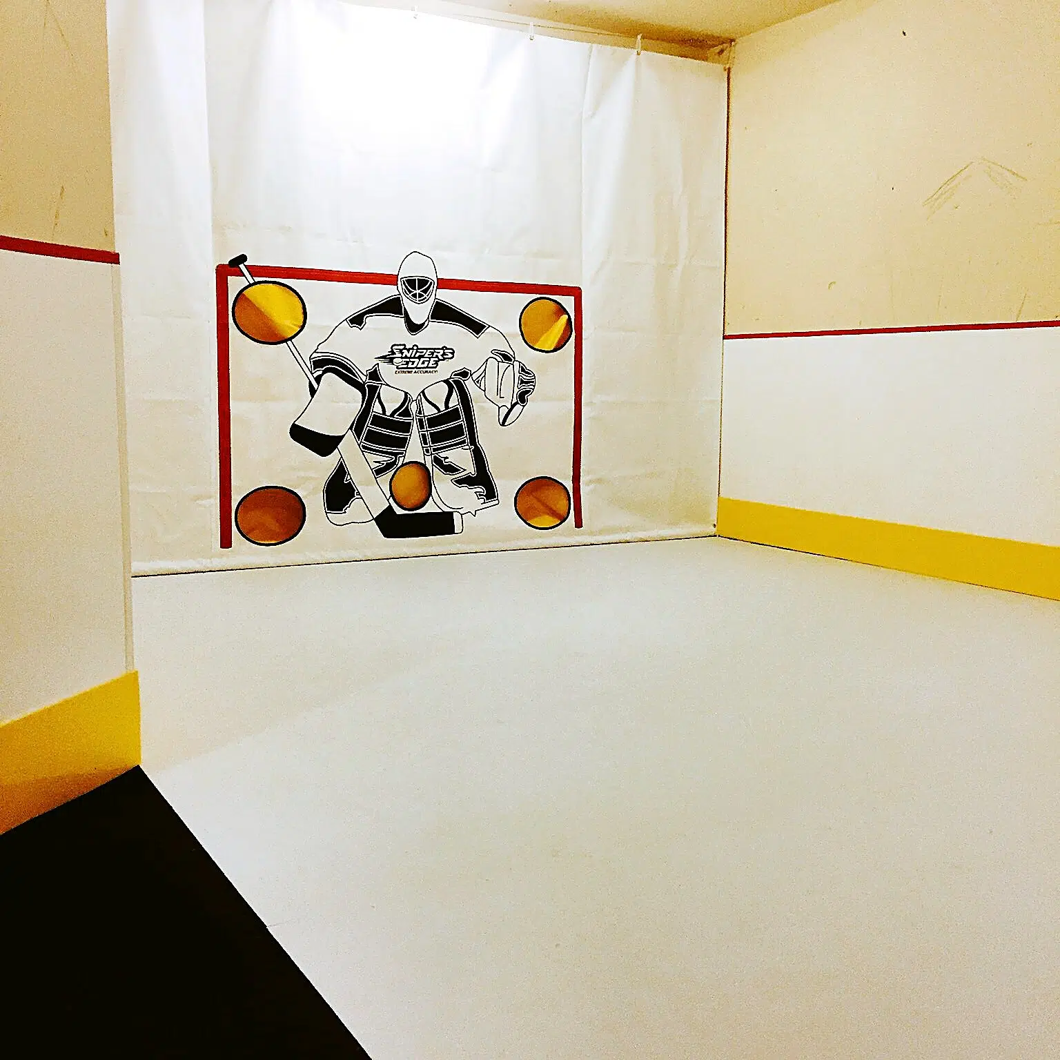 Home synthetic ice rink built in a basement for hockey training